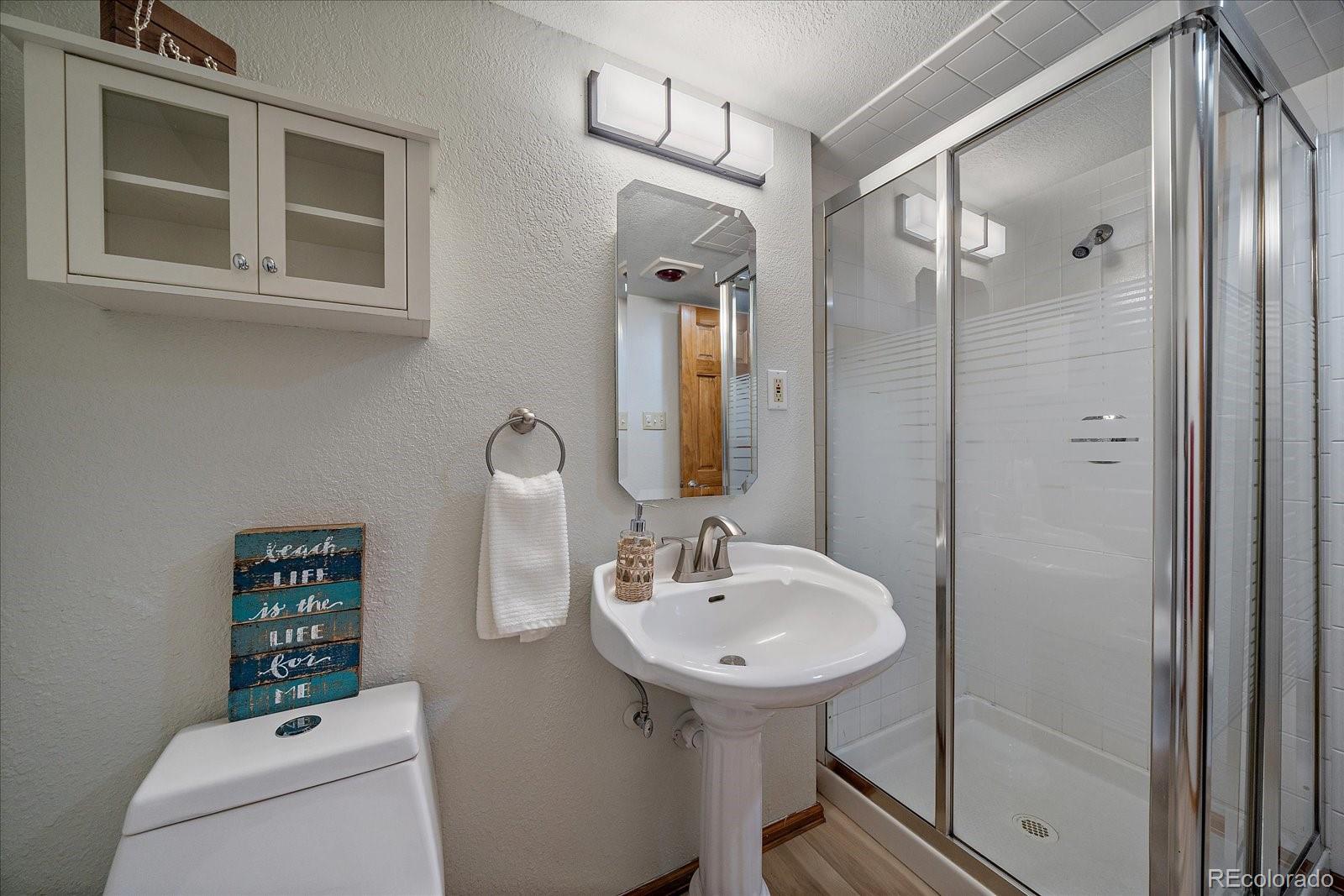 10961 Gray Circle Westminster, CO 80020 - Photo 13 of 24 a bathroom with a sink a toilet and shower