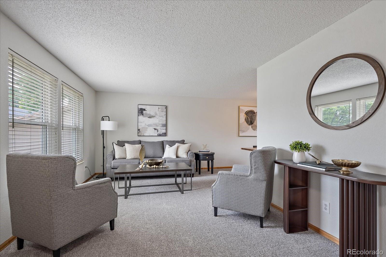 10961 Gray Circle Westminster, CO 80020 - Photo 2 of 24 a living room with furniture and a mirror