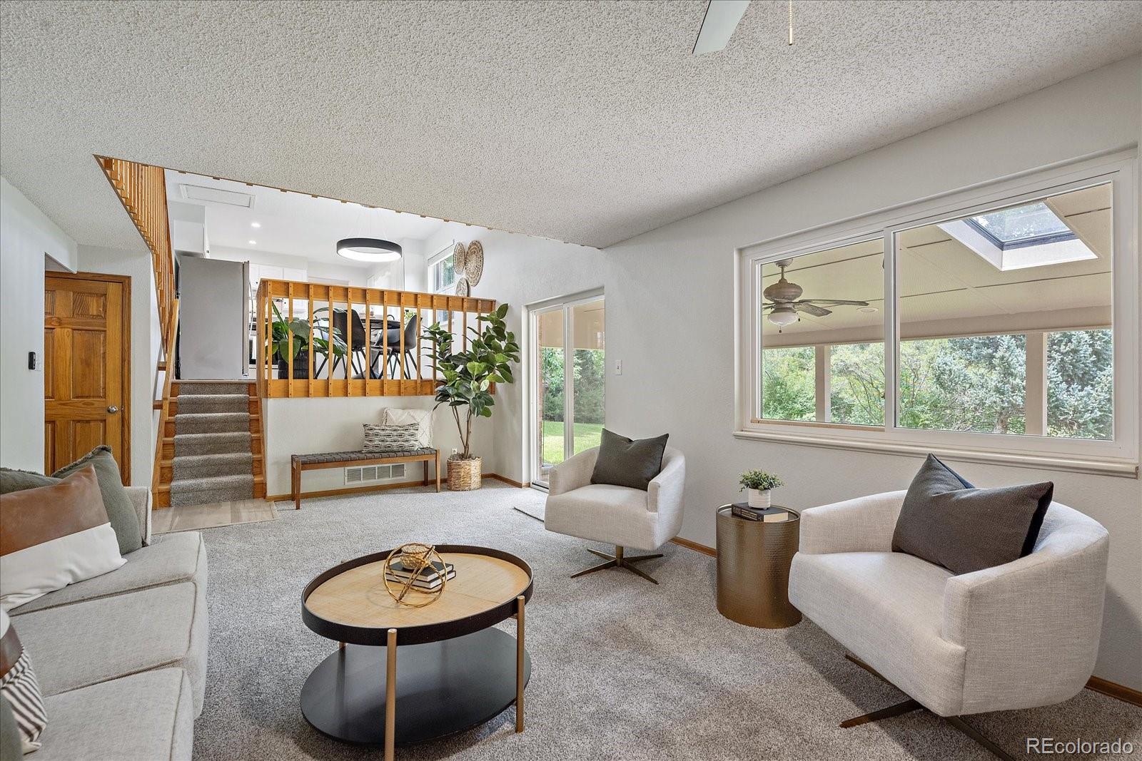 10961 Gray Circle Westminster, CO 80020 - Photo 10 of 24 a living room with furniture and a large window