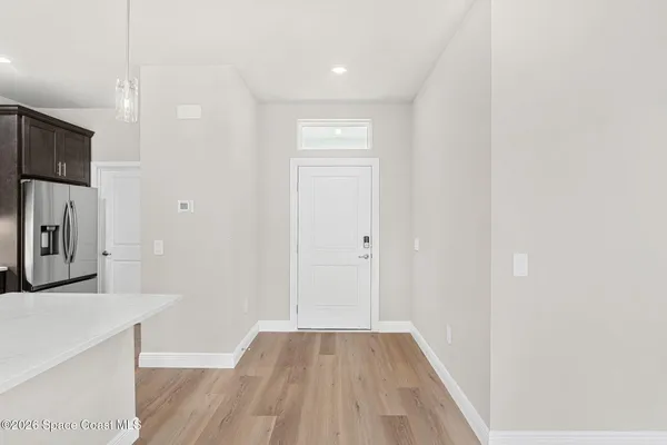 a view of a kitchen from the hallway