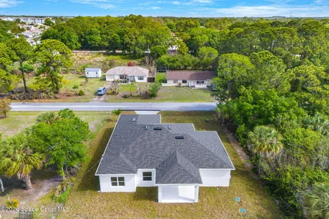a aerial view of a house with swimming pool