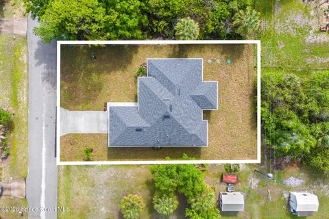 an aerial view of residential house with outdoor space and swimming pool