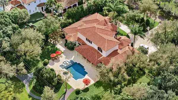 an aerial view of a house with a yard and garden