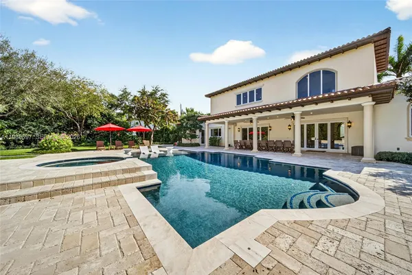 a view of house with swimming pool outdoor seating