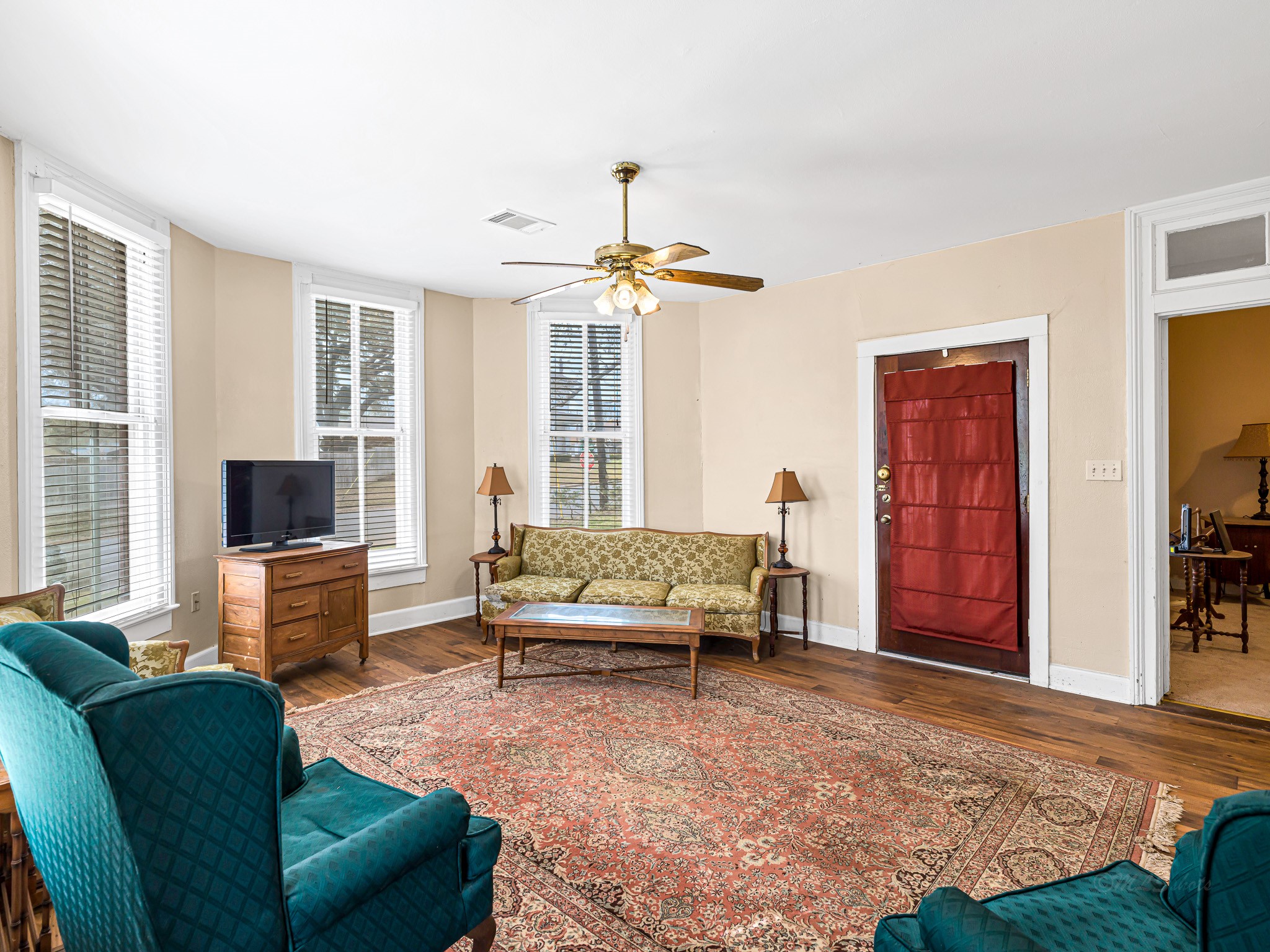 26 West Austin Street Bellville, TX 77418 - Photo 8 of 40 A striking antique glass front door framed in rich mahogany welcomes you into the home and reflects the property’s timeless craftsmanship.