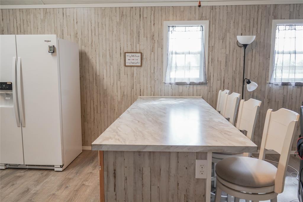 386 North Rock Creek Road Waco, TX 76708 - Photo 11 of 40 a view of kitchen with wooden floor and chairs