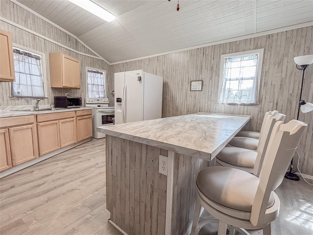 386 North Rock Creek Road Waco, TX 76708 - Photo 14 of 40 a kitchen with stainless steel appliances granite countertop a table chairs and a refrigerator
