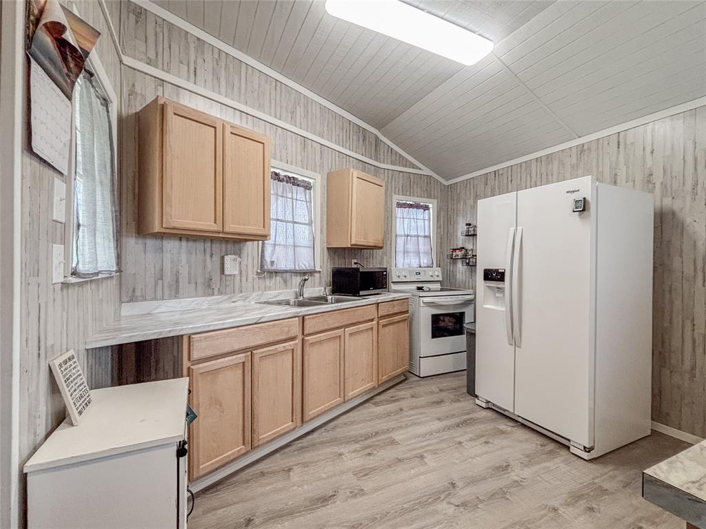 386 North Rock Creek Road Waco, TX 76708 - Photo 15 of 40 a kitchen with white cabinets and white appliances