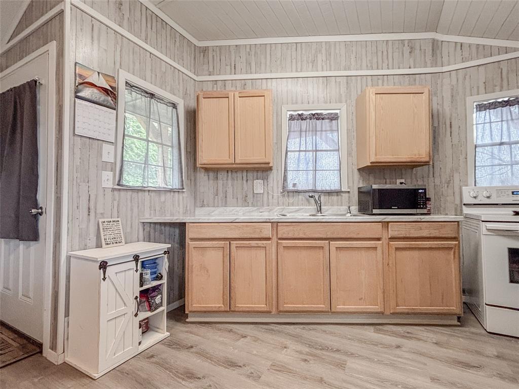 386 North Rock Creek Road Waco, TX 76708 - Photo 16 of 40 a kitchen with stainless steel appliances granite countertop a stove a sink and a refrigerator