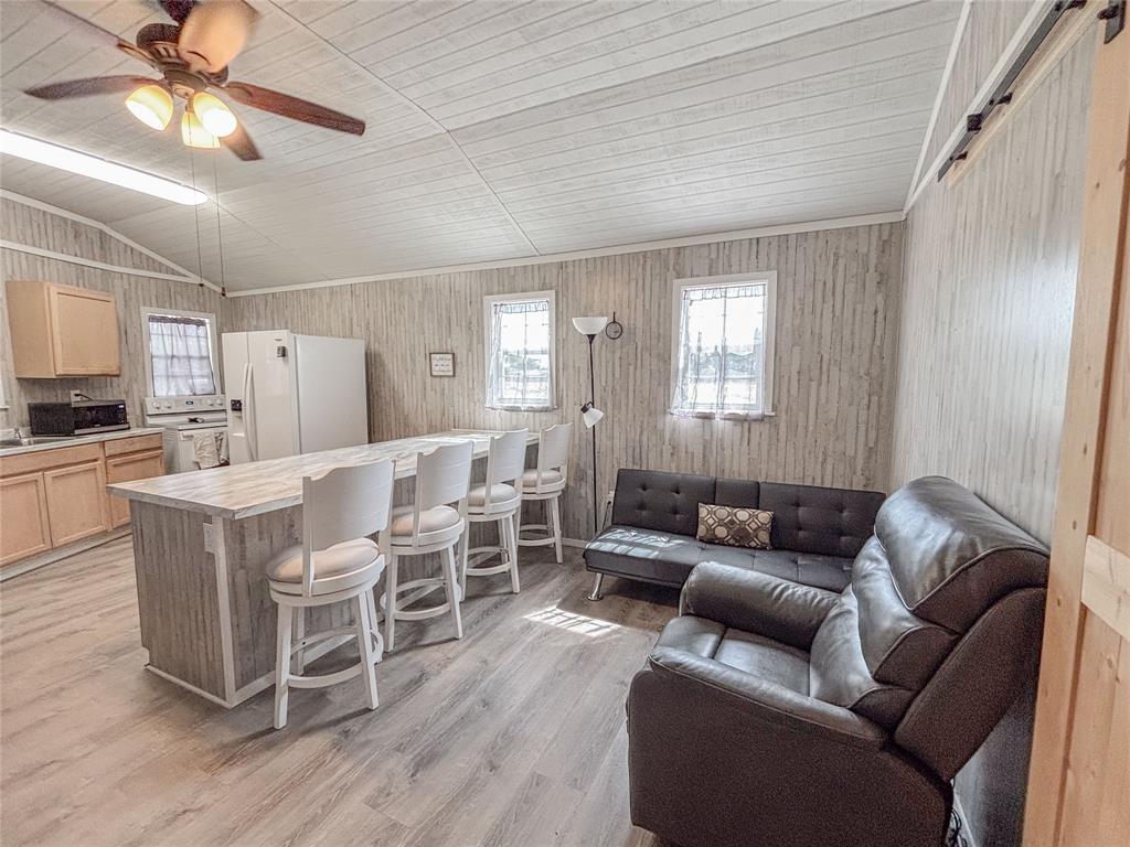 386 North Rock Creek Road Waco, TX 76708 - Photo 19 of 40 a living room with furniture and a wooden floor