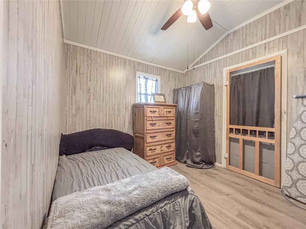 386 North Rock Creek Road Waco, TX 76708 - Photo 22 of 40 a bedroom with a bed and cabinets