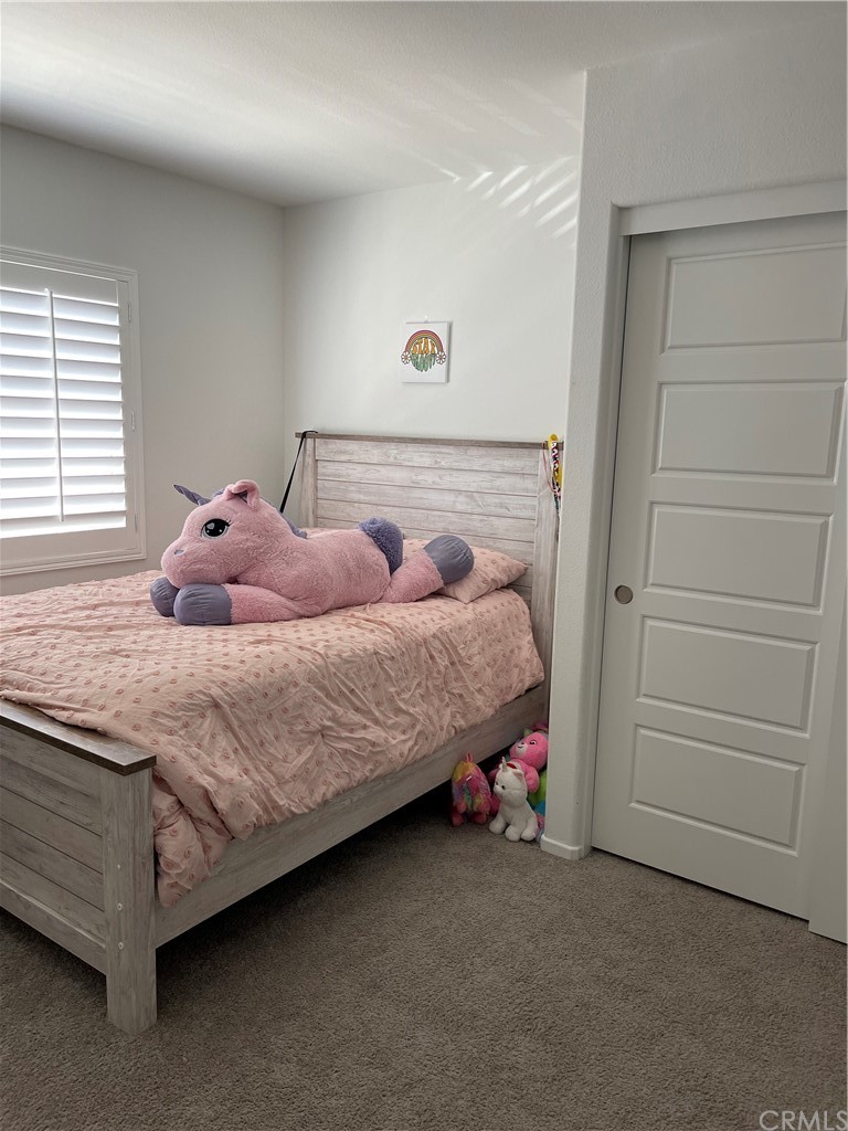 5895 Nectar Drive Banning, CA 92220 - Photo 12 of 29 a bedroom with a bed and a window