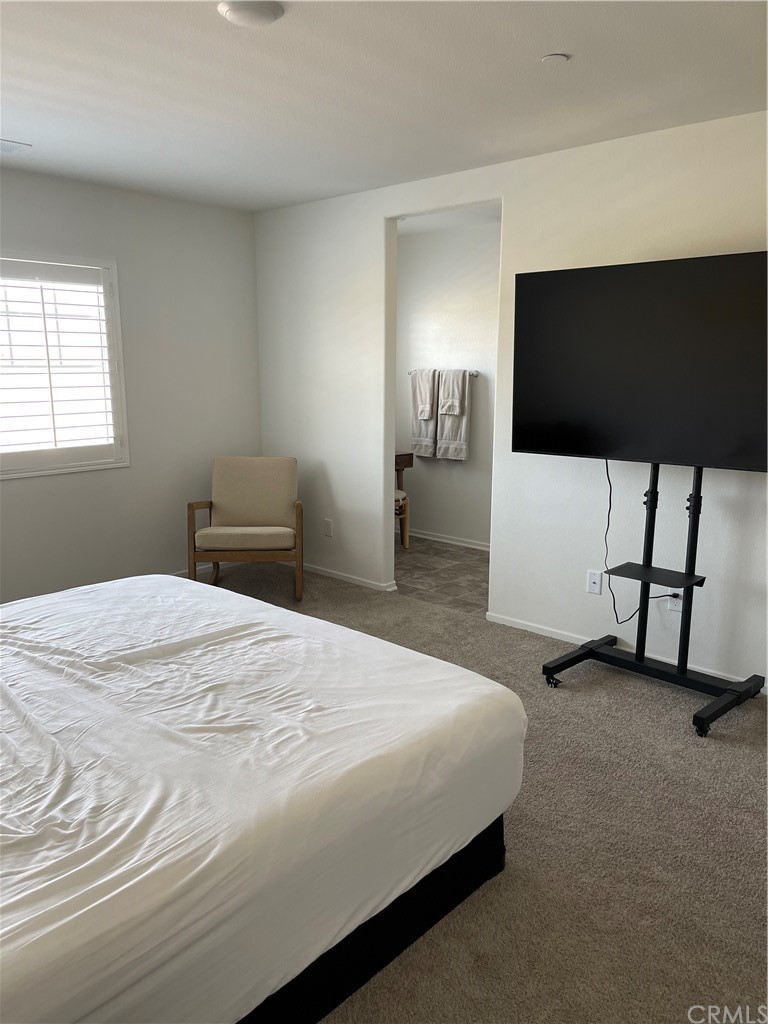 5895 Nectar Drive Banning, CA 92220 - Photo 13 of 29 a bedroom with a bed and a flat screen tv