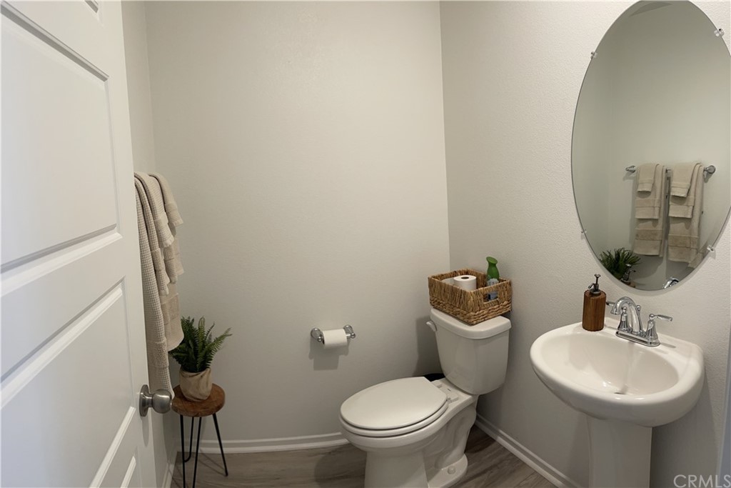 5895 Nectar Drive Banning, CA 92220 - Photo 6 of 29 a bathroom with a toilet a sink and a mirror