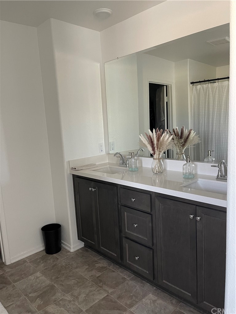 5895 Nectar Drive Banning, CA 92220 - Photo 7 of 29 a bathroom with a double vanity sink and a mirror