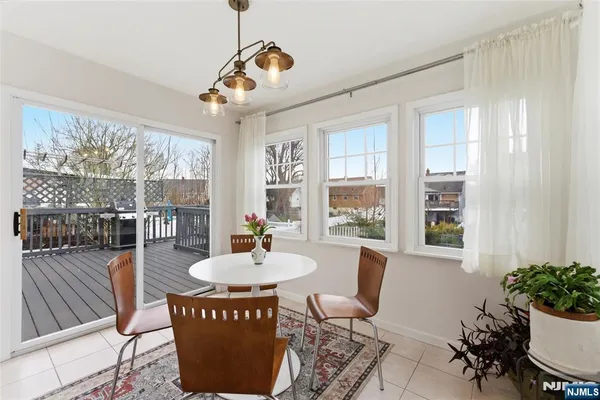 a dining room with furniture a chandelier and wooden floor