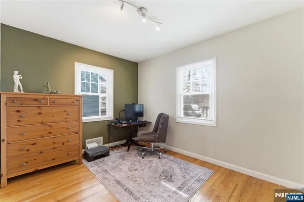 a view of a workspace with furniture and a window