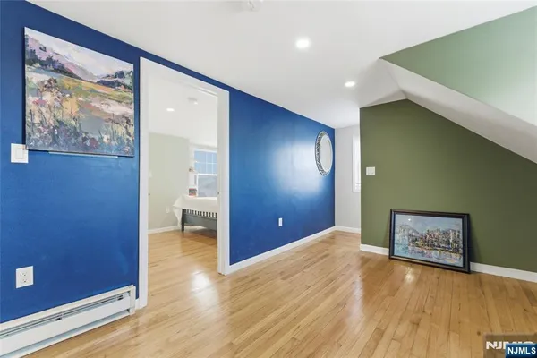a view of a big room with wooden floor and windows