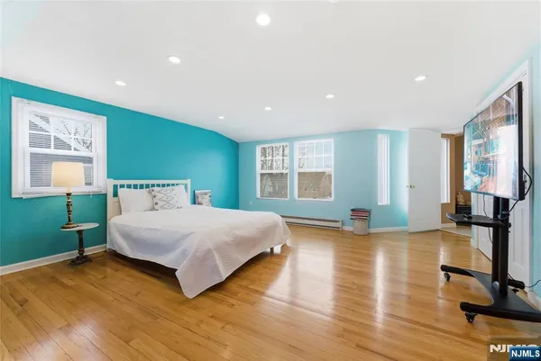 a spacious bedroom with a large bed and a window