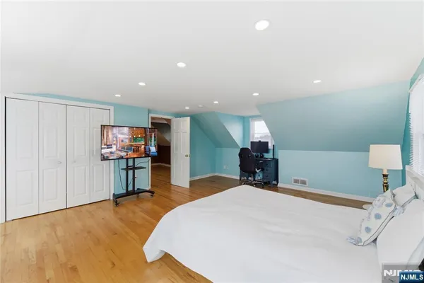 a bed room with a bed and a television