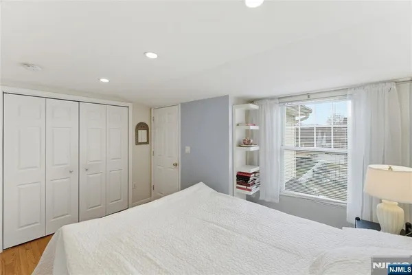 a bedroom with a large bed and a window