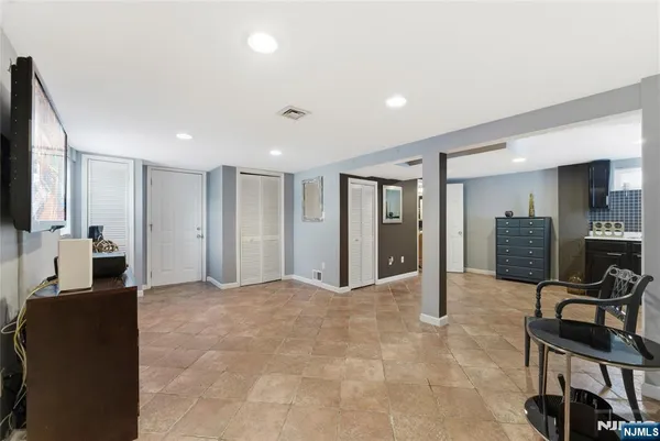 a view of a livingroom with furniture and a flat screen tv