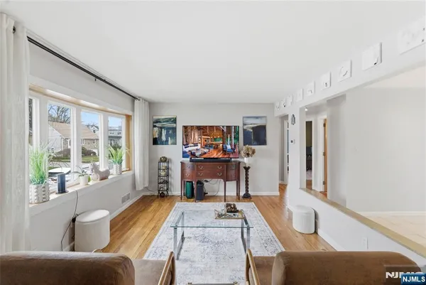 a dining room with furniture and a large window