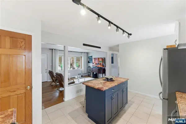 a kitchen with a refrigerator and a sink