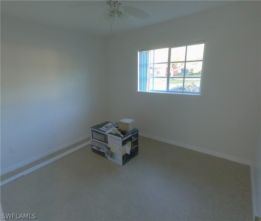 4631 29th Street Southwest Lehigh Acres, FL 33973 - Photo 4 of 10 an empty room with a window