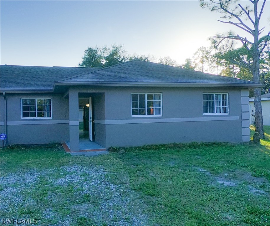 4631 29th Street Southwest Lehigh Acres, FL 33973 - Photo 7 of 10 front view of a house with a yard