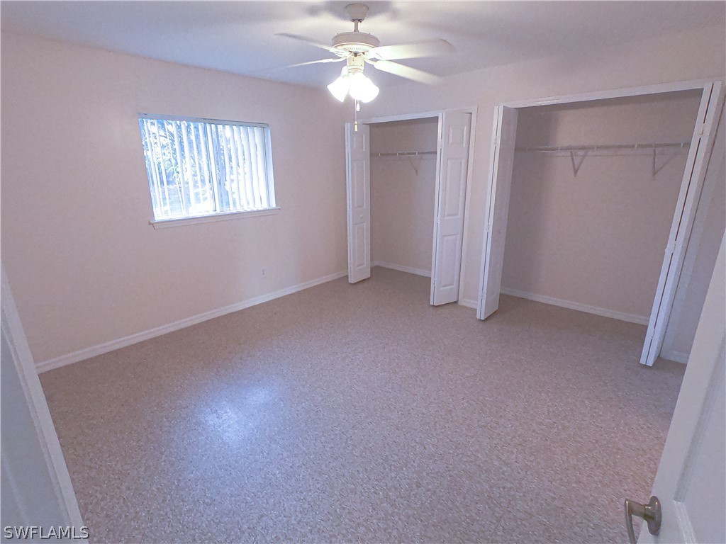 4631 29th Street Southwest Lehigh Acres, FL 33973 - Photo 9 of 10 an empty room with windows and fan