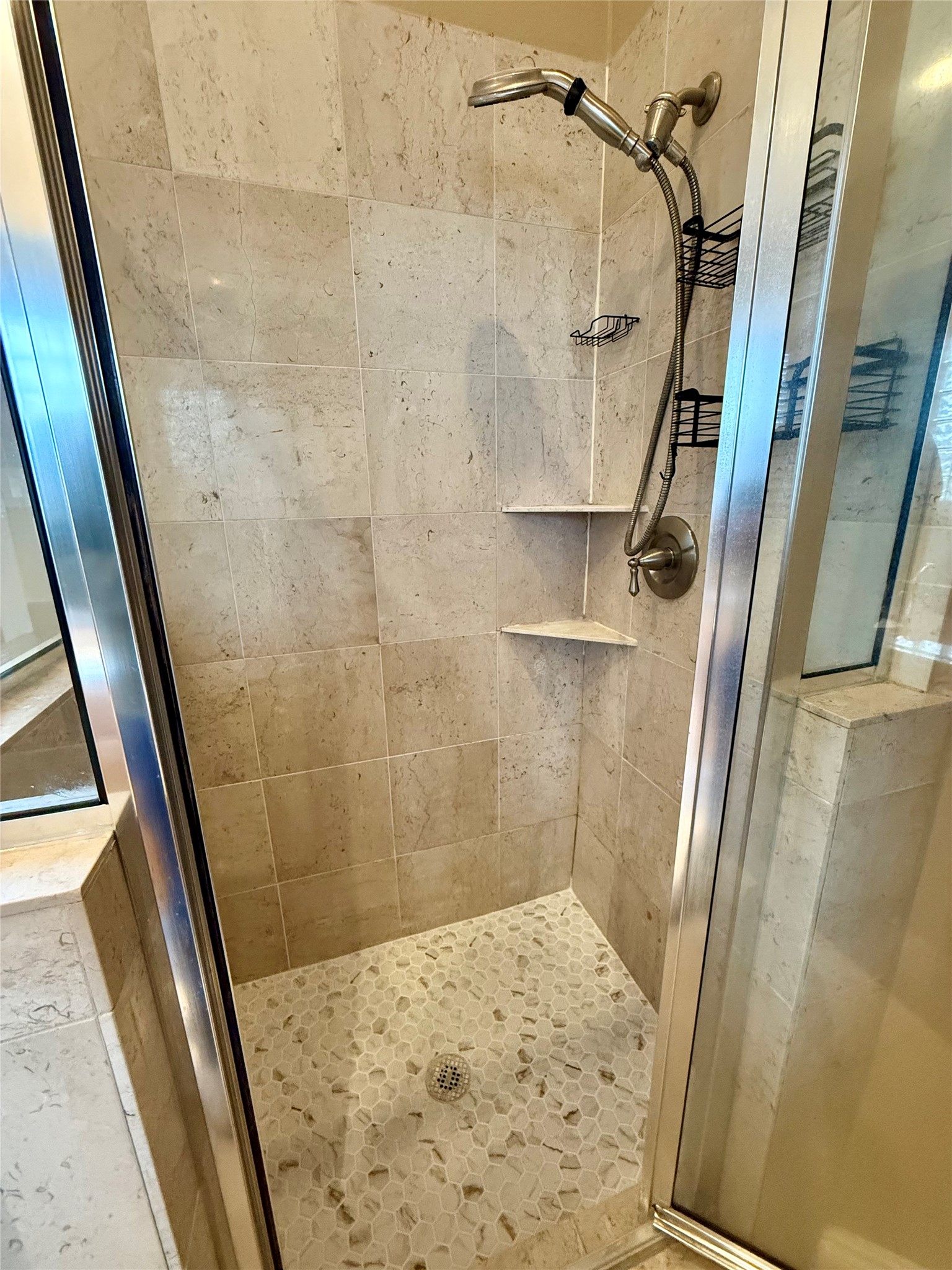 3540 Cline Street Houston, TX 77020 - Photo 14 of 26 Detailed view of the custom-tiled walk-in shower with built-in shelving and glass door.