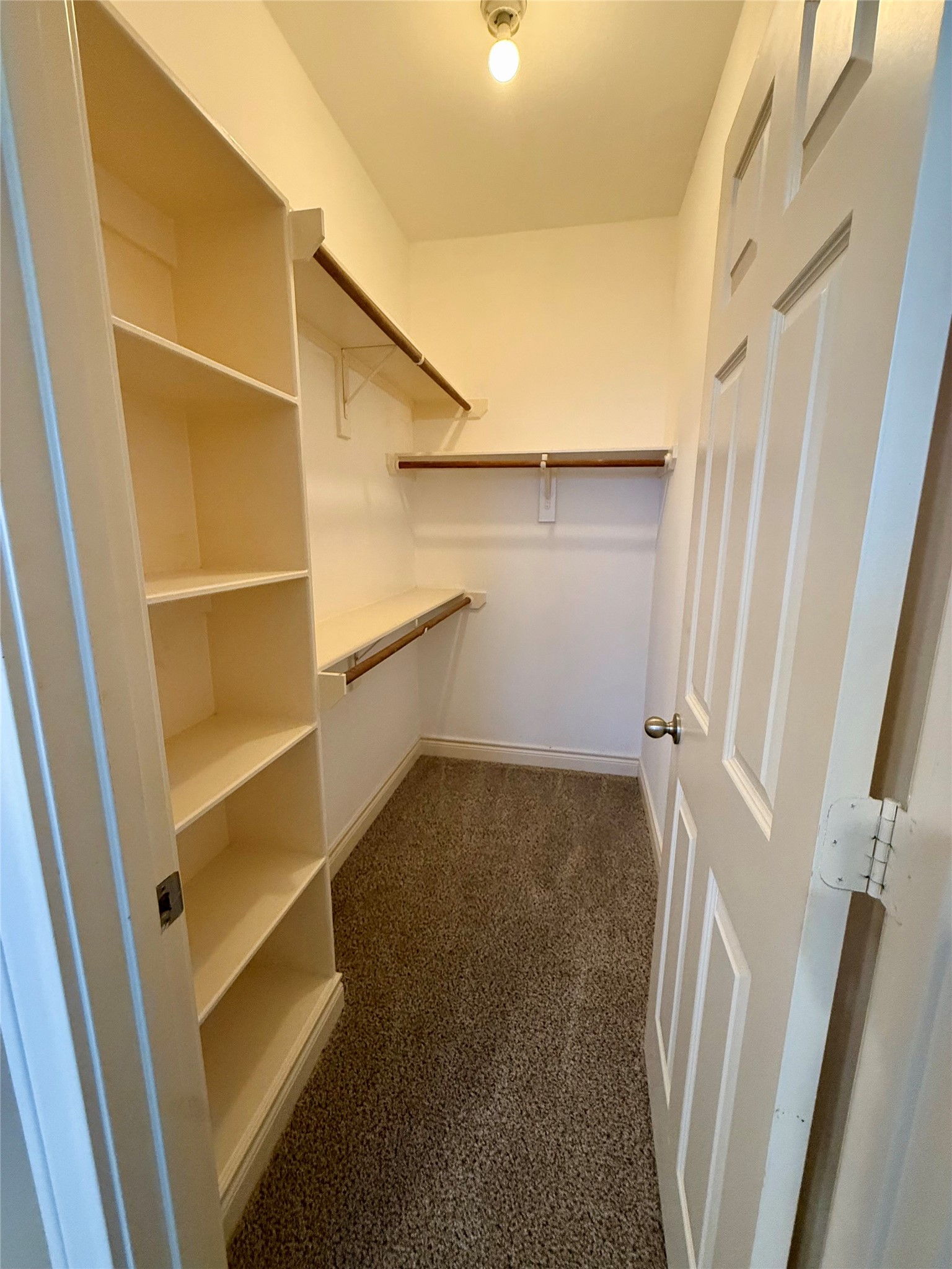 3540 Cline Street Houston, TX 77020 - Photo 15 of 26 Massive walk-in closet with extensive built-in shelving and hanging rods for maximum organization.