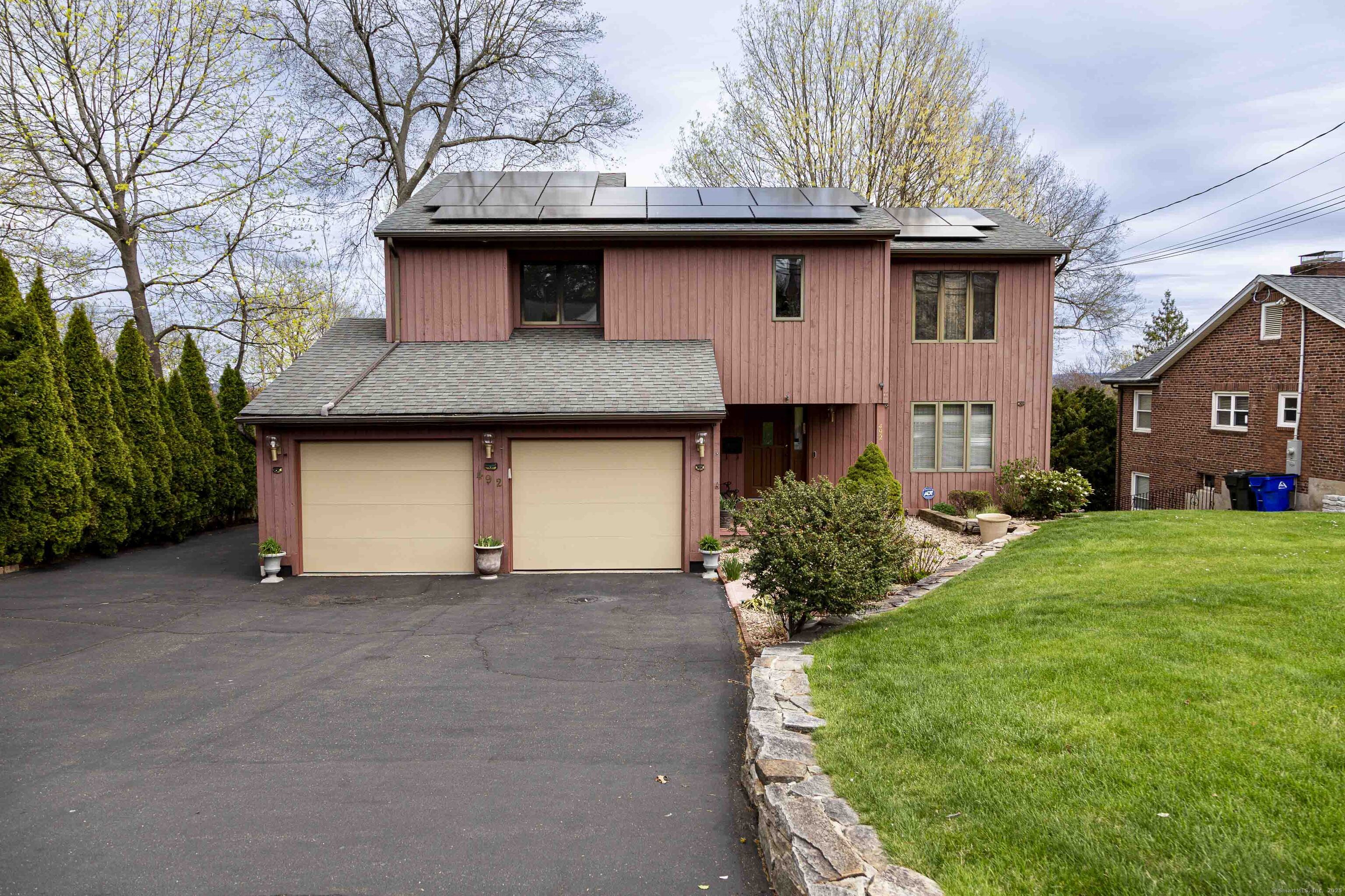 492 Ridge Road Wethersfield, CT 06109 - Photo 1 of 1 a front view of a house with a yard and garage
