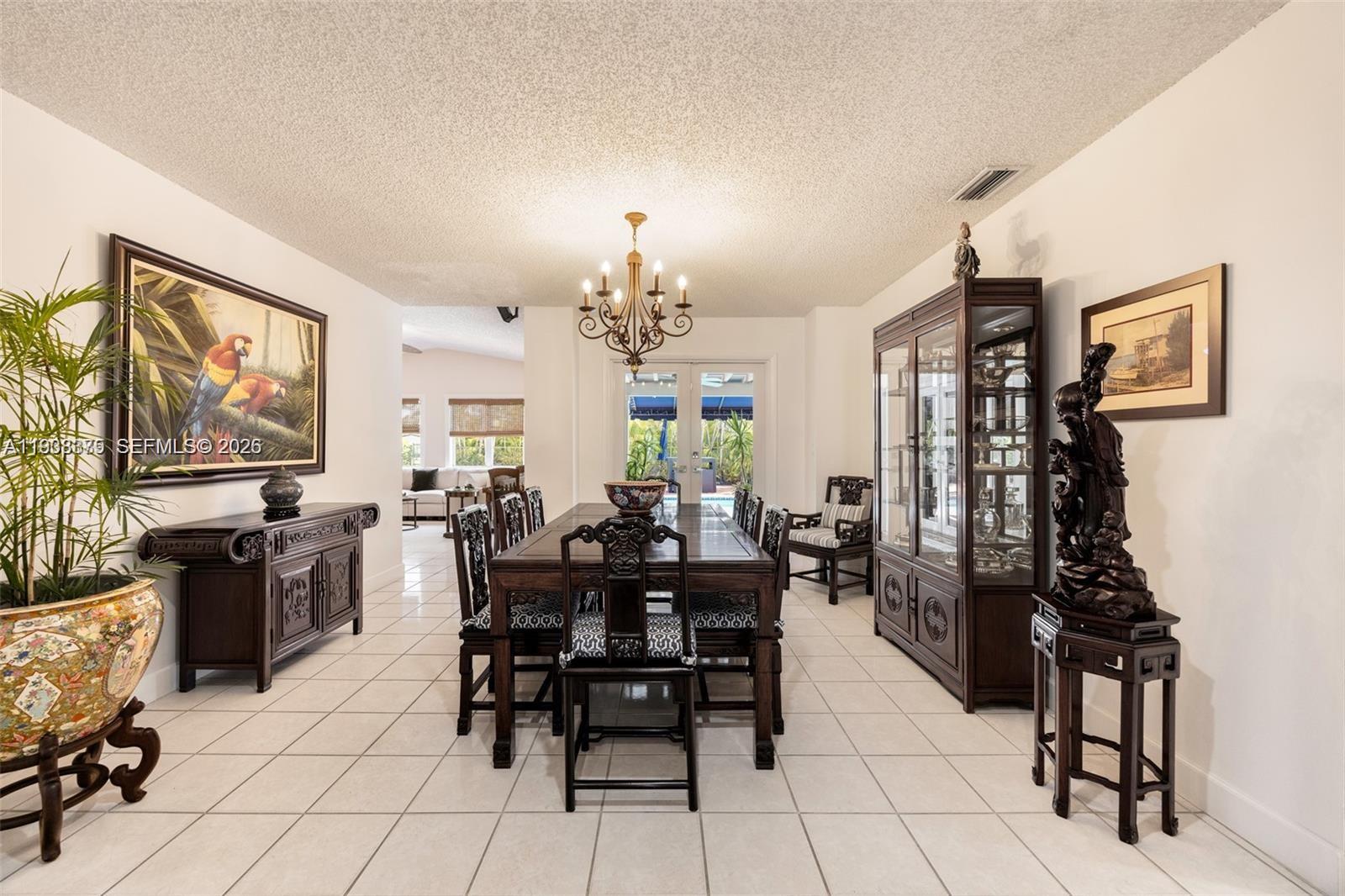 8610 Southwest 83rd Street Miami, FL 33143 - Photo 11 of 45 a view of a dining room with furniture and chandelier