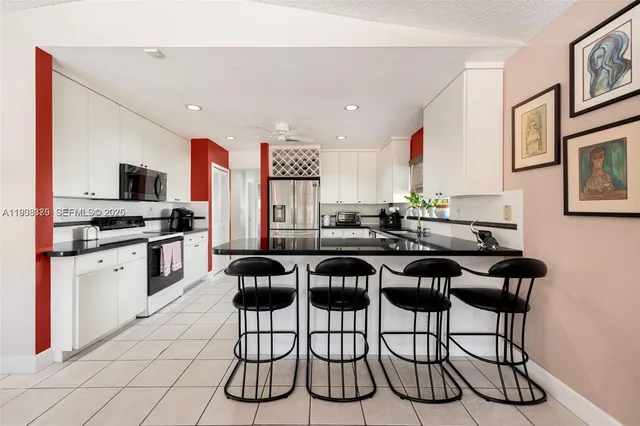 a kitchen with a table chairs stove and cabinets