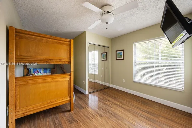 a view of a room with wooden floor and a window