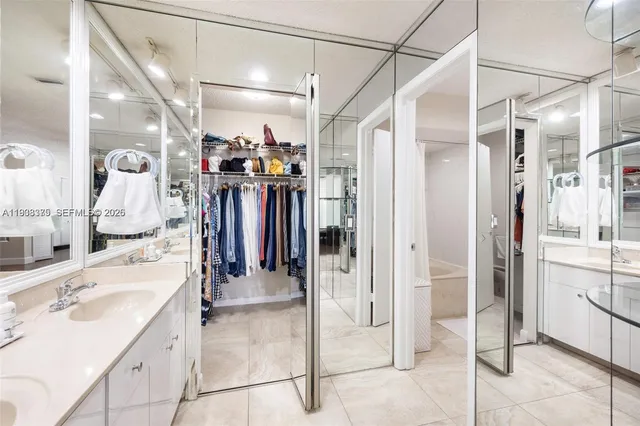 a view of walk in closet with clothes