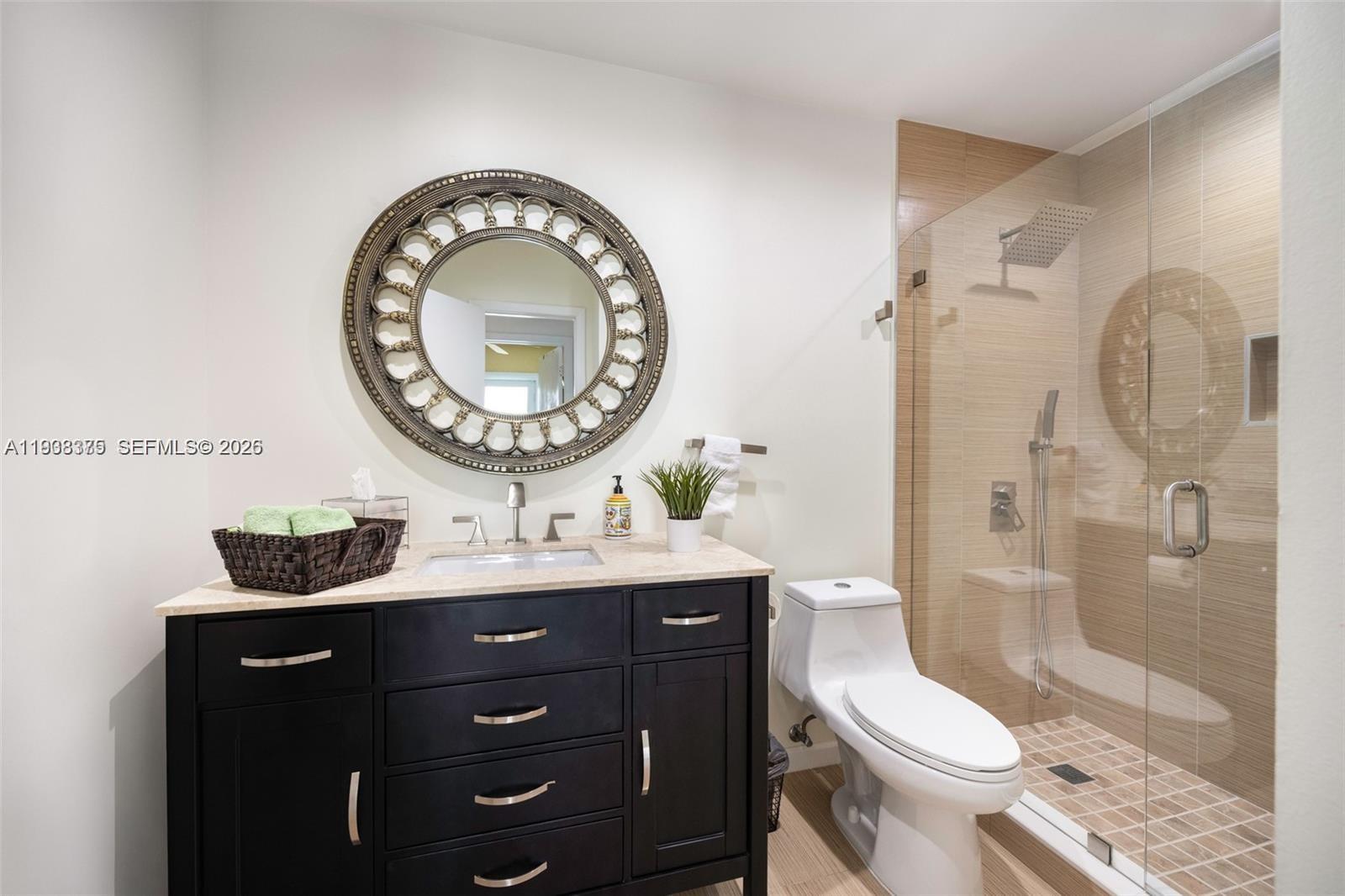 8610 Southwest 83rd Street Miami, FL 33143 - Photo 30 of 45 a bathroom with a toilet a sink and a shower