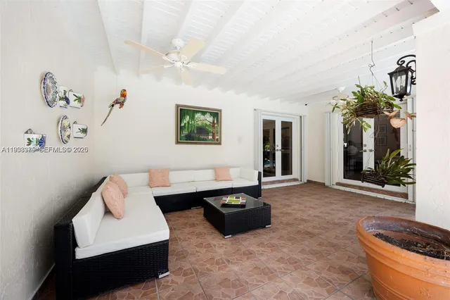 a living room with patio furniture and a fountain