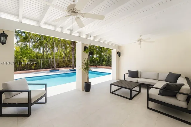 a view of a swimming pool with a patio and a garden