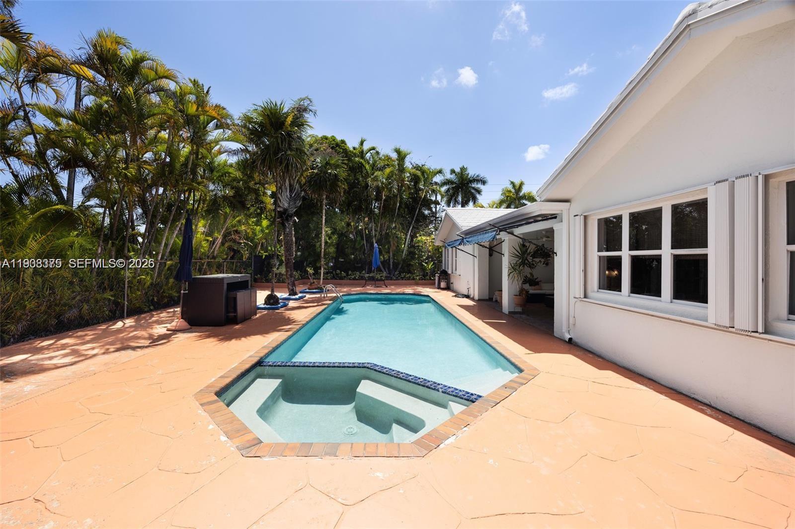 8610 Southwest 83rd Street Miami, FL 33143 - Photo 37 of 45 a view of a house with backyard and sitting area