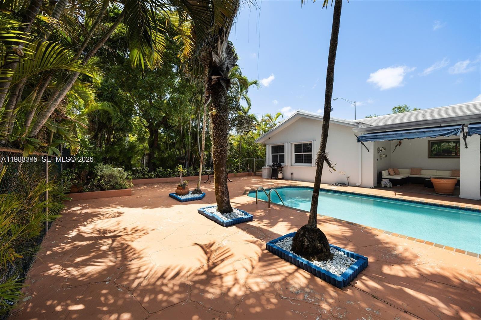 8610 Southwest 83rd Street Miami, FL 33143 - Photo 38 of 45 a view of a swimming pool with a patio