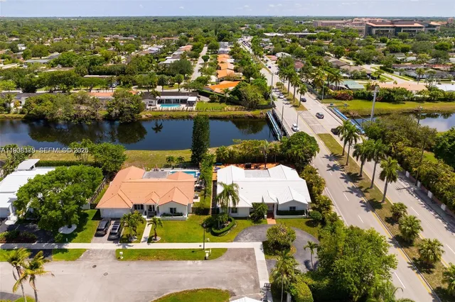 an aerial view of residential house with outdoor space and swimming pool