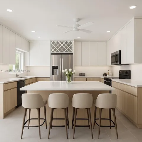 a kitchen with a sink and chairs
