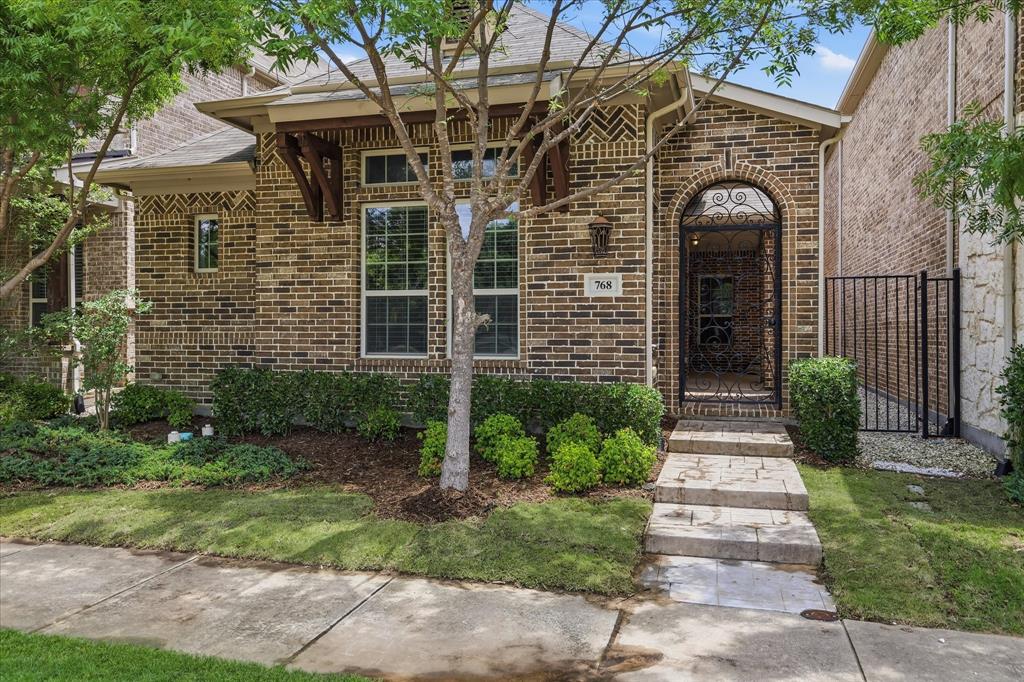 768 Huntingdon Street Coppell, TX 75019 - Photo 32 of 37 A graceful arched entry with decorative ironwork adds character and elegance before you even step inside.
