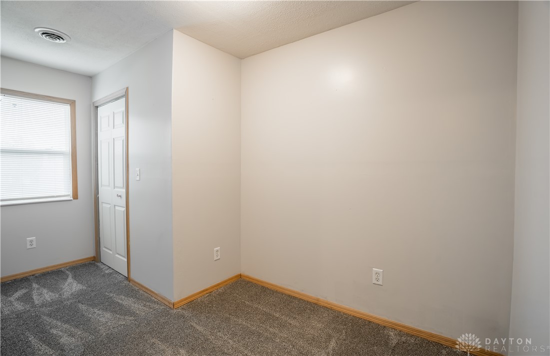 1442 Langdon Road Sidney, OH 45365 - Photo 23 of 34 This cozy bedroom features plush carpeting and ample natural light, creating a comfortable and inviting atmosphere.