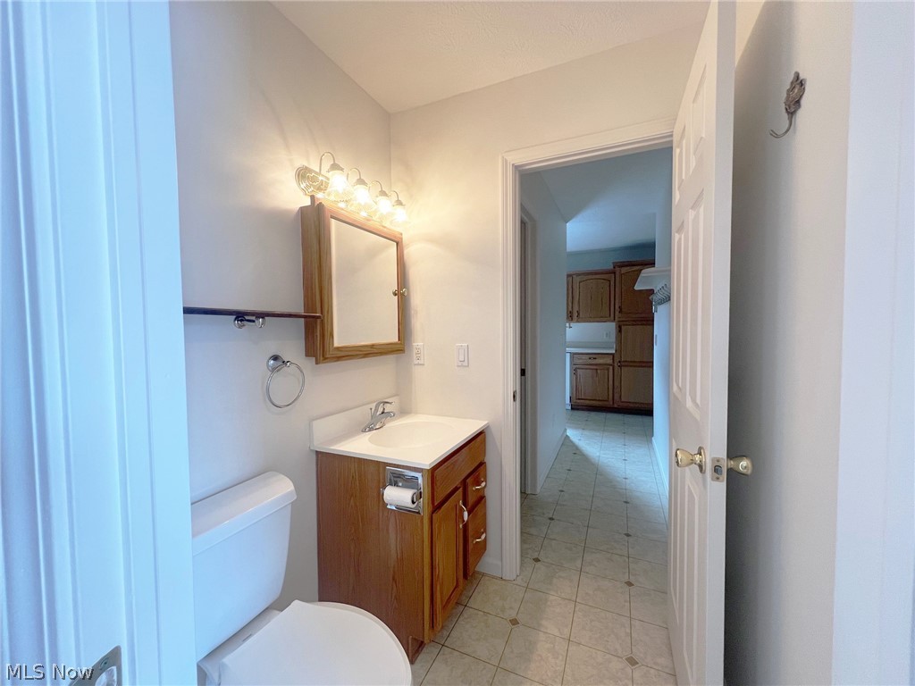 5203 Ridgeland Street Lorain, OH 44055 - Photo 6 of 39 Bathroom featuring tile floors, large vanity, and toilet