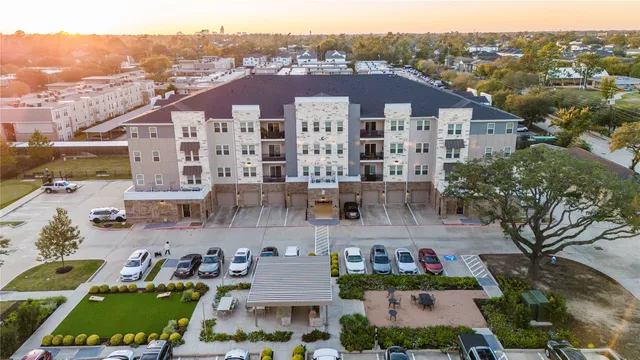 an aerial view of residential houses with outdoor space and ocean view