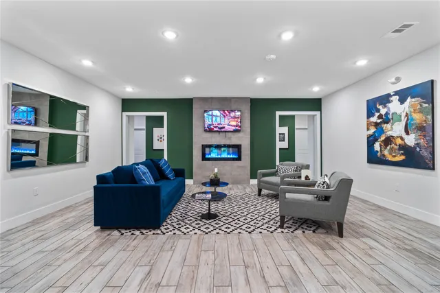 a living room with furniture and a wooden floor